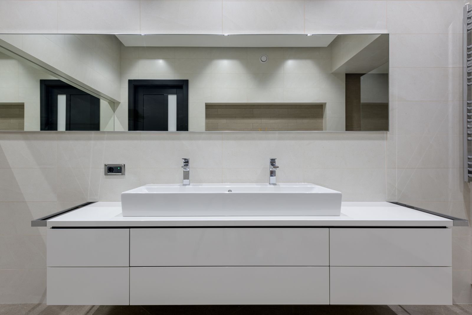 Bathroom vanity with a mirror and white countertop