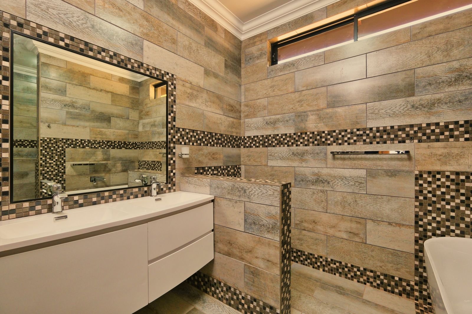 Bathroom with mosaic tile and a large mirror